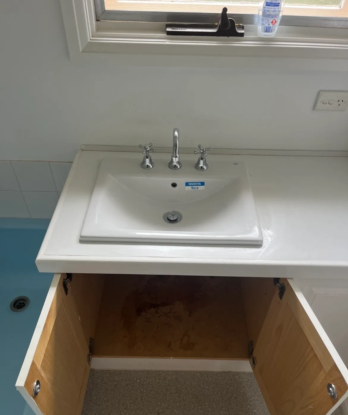 White ceramic drop-in sink with a three-hole widespread faucet set