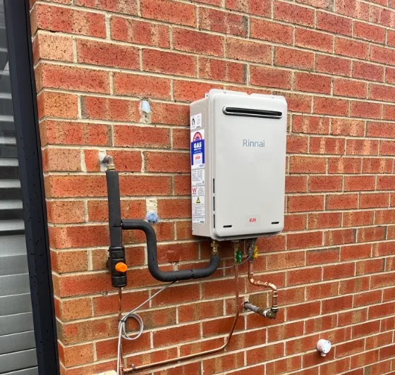Rinnai continuous flow hot water system on a brick wall