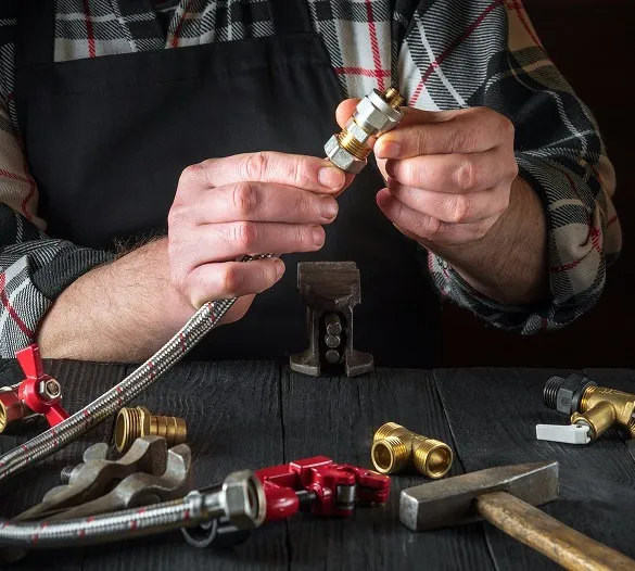Plumber assembling a brass hose fitting
