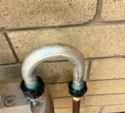 Gas meter with copper pipe connection and a small compliance label