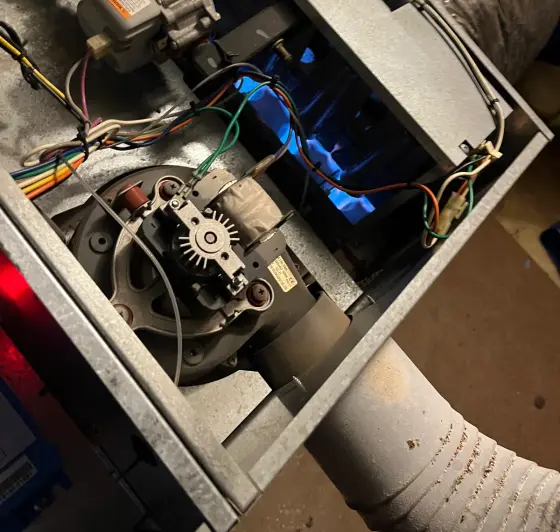 Inside of a gas heater with a blue flame at the burner