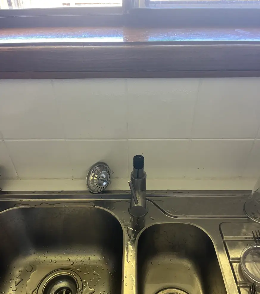 Stainless steel double kitchen sink with a mixer tap